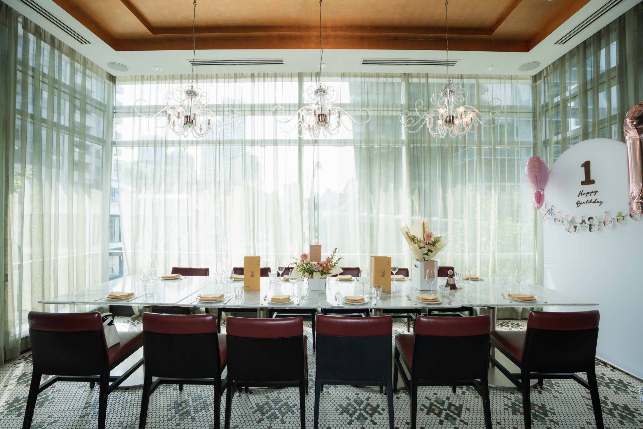 A bright birthday dinner set with flowers and warm candlelight