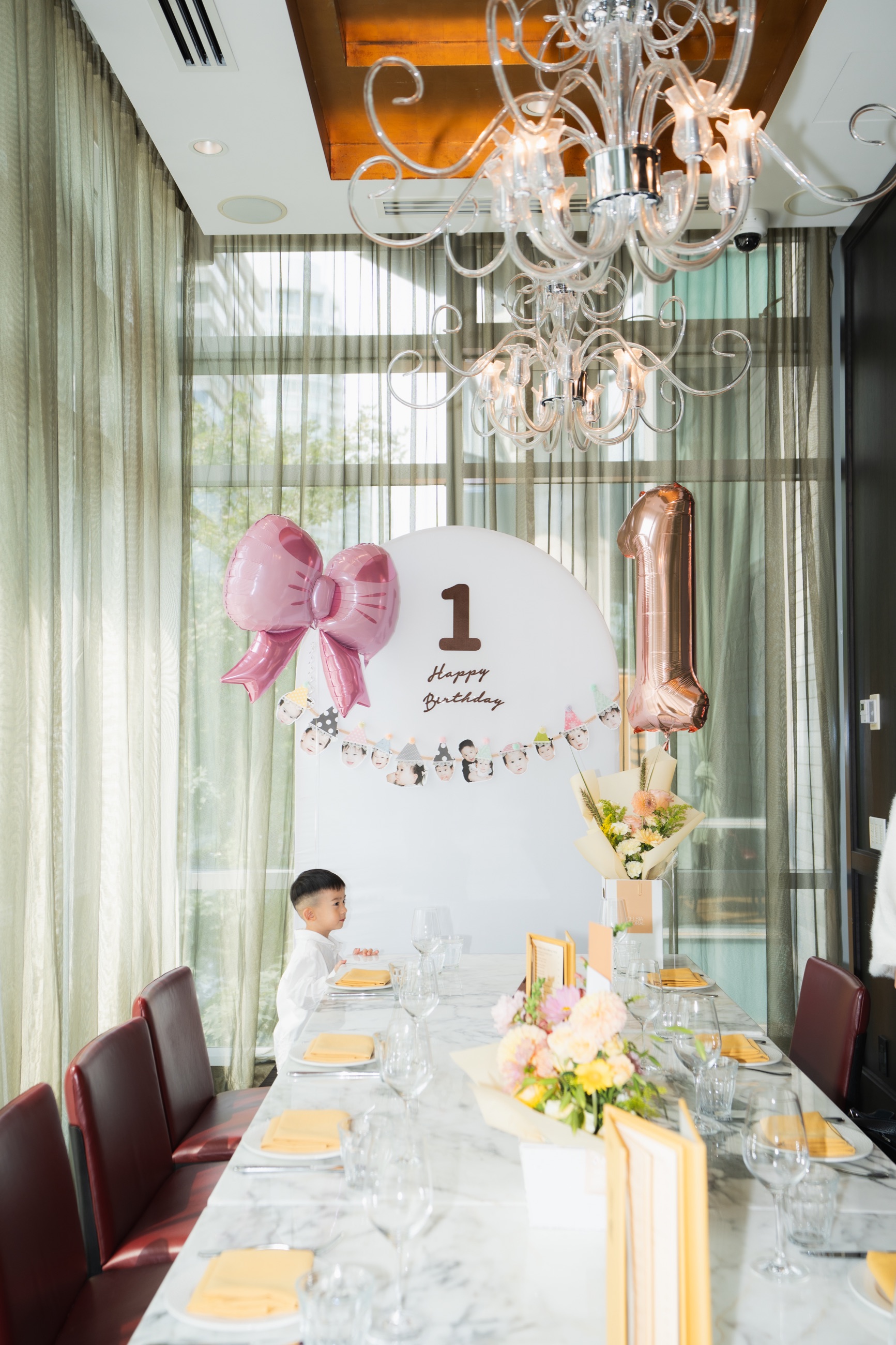 A birthday tablescape with flowers, candles, and personalized details