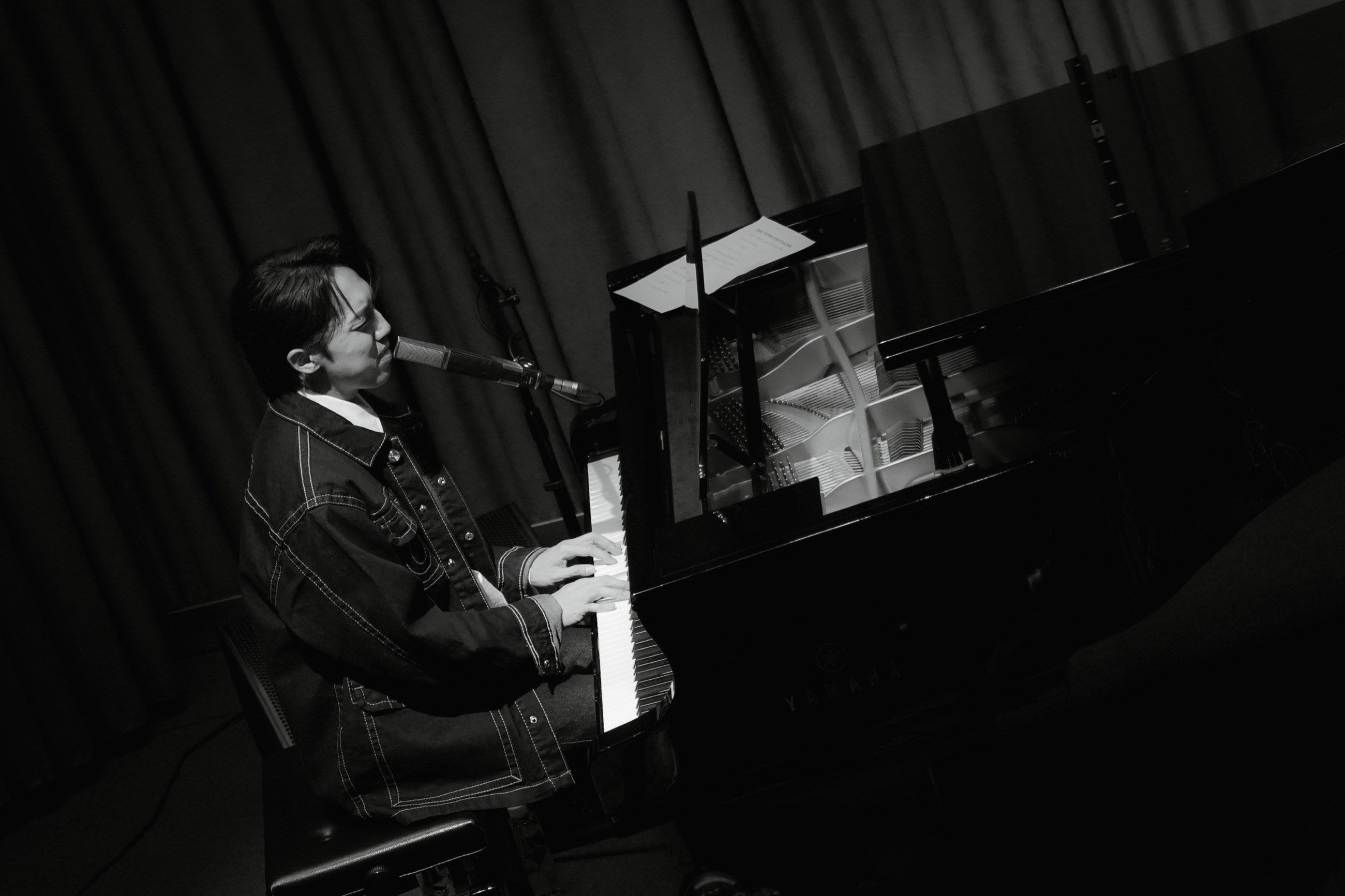 A monochrome overhead view of the pianist at the keyboard