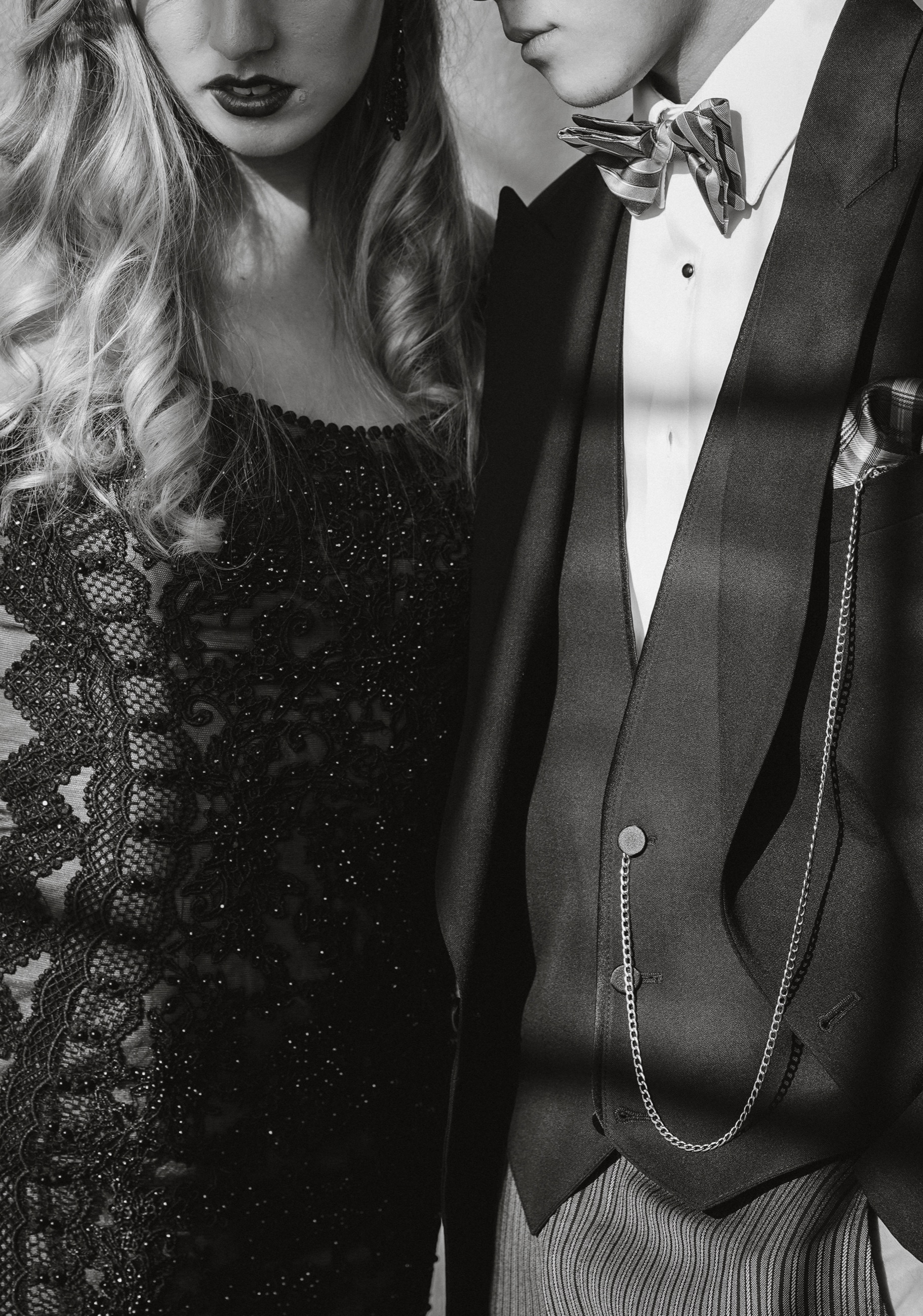 A monochrome close-up of eveningwear textures and tailoring