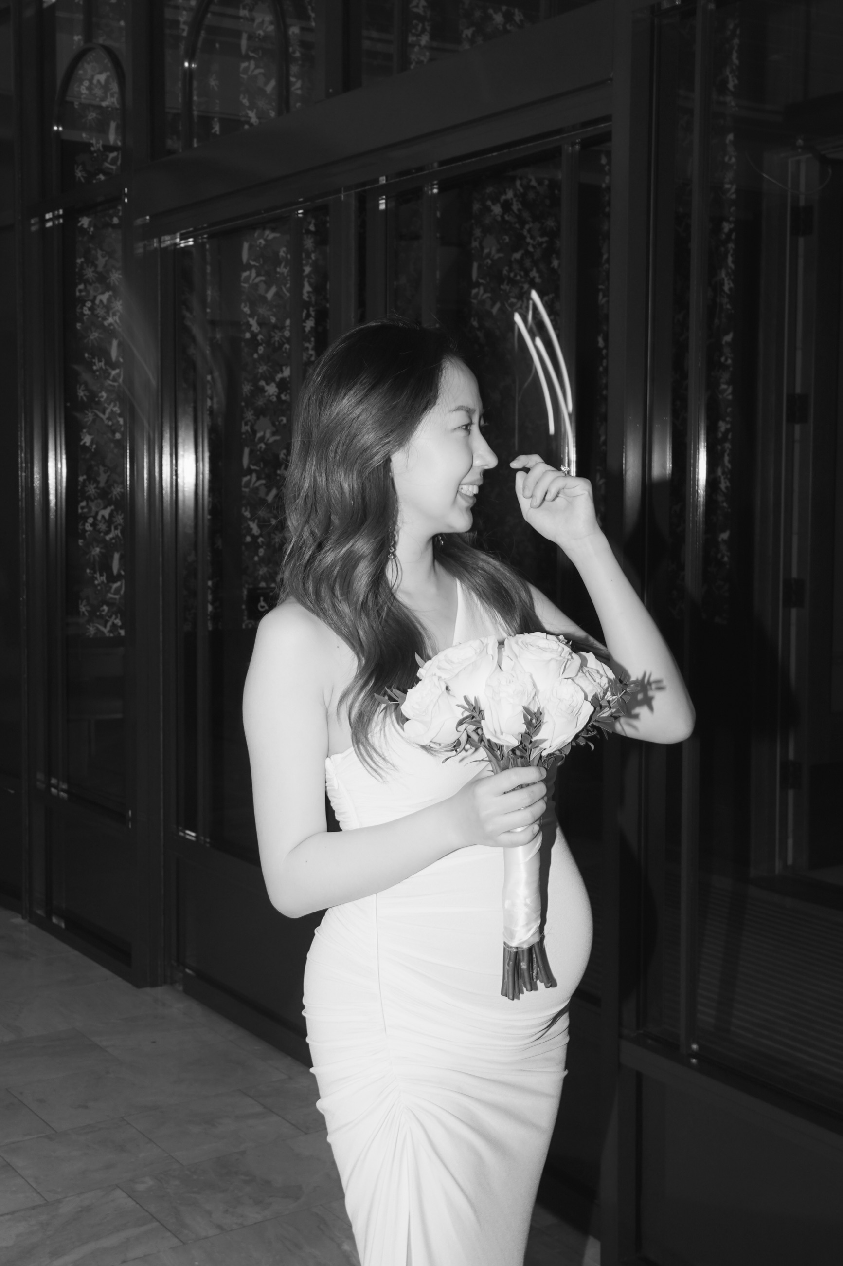 A monochrome portrait of the bride holding her bouquet