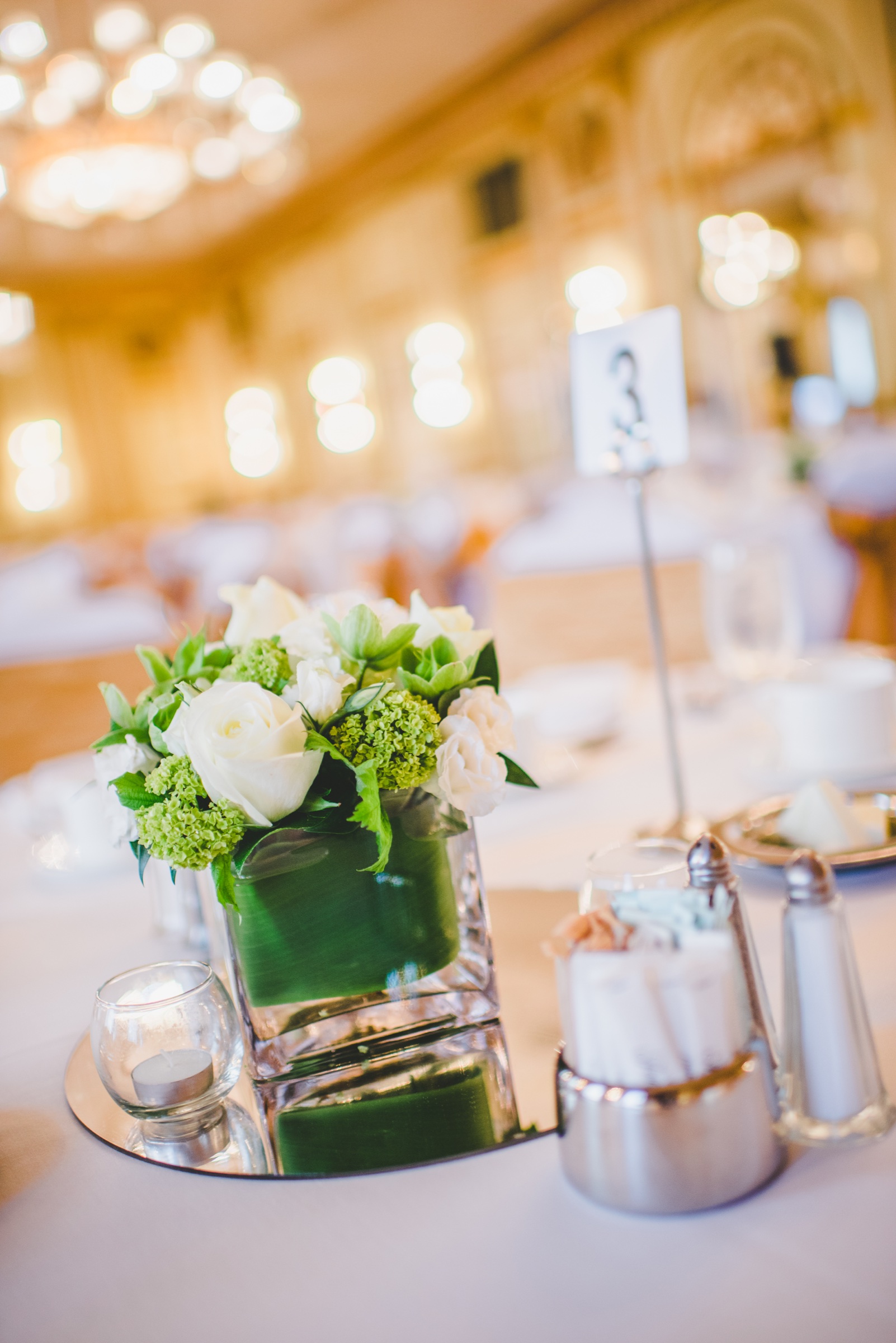 Floral centrepiece and table setting in an elegant ballroom